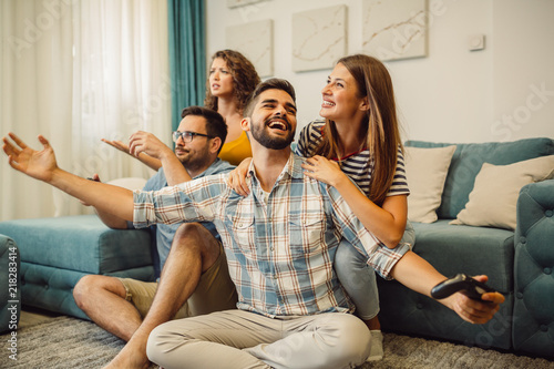 Someone must win! Group of friends is having fun while playing video games.