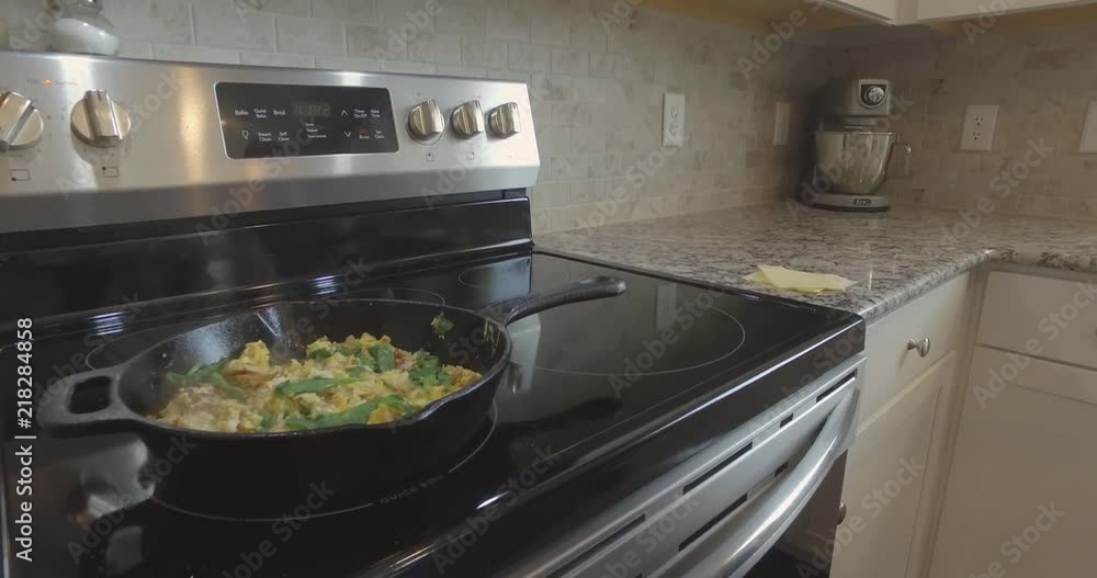 Steaming Cast Iron Pan with Egg, Muenster Cheese, Spinach, and Potatoes Omlette Steaming Cast Iron Pan with Egg, Muenster Cheese, Spinach, and Potatoes Omlette