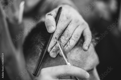 Hair Care. Barber makes a haircut with scissors. Soft focus.