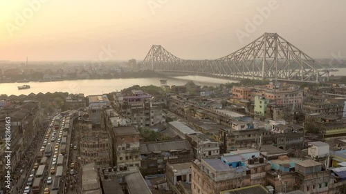 Beautiful sunset view of Kolkata city with a Howrah bridge on the Ganga river, West Bengal, India. photo