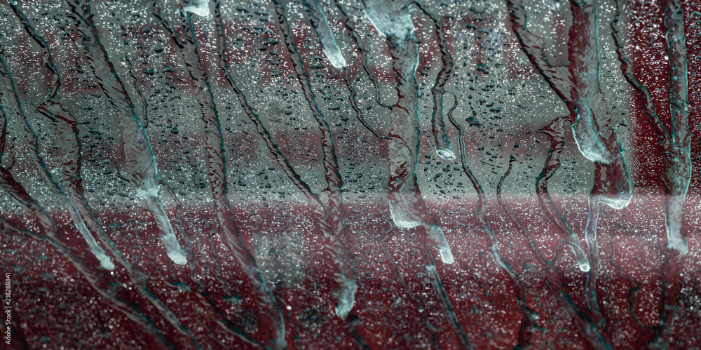 Fototapeta premium background. defocusing. the windshield of the car in the car wash. beautiful water jets on the glass