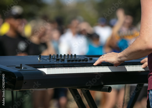 Keyboard in outdoor park concert bokeh audience