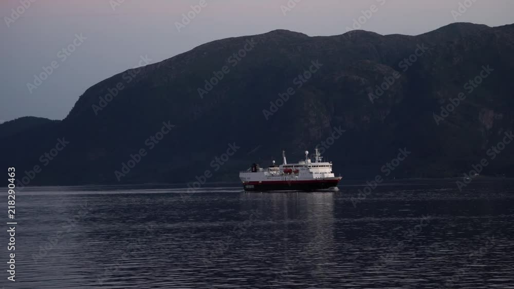 Big ferry sailing over ocean with mountain background. Big ferry sailing over ocean with mountain background.
