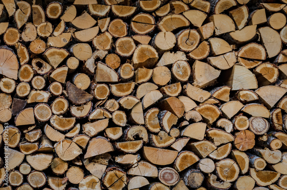 Wooden background. Firewood drying for the winter, stacks of firewood Wooden background. Firewood drying for the winter, stacks of firewood