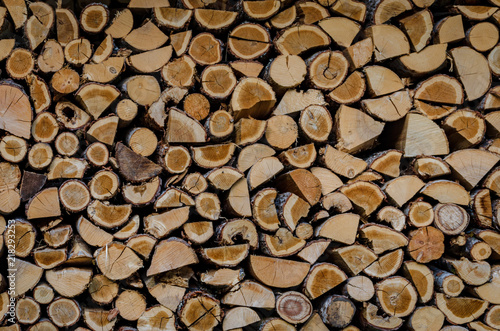 Wooden background. Firewood drying for the winter  stacks of firewood