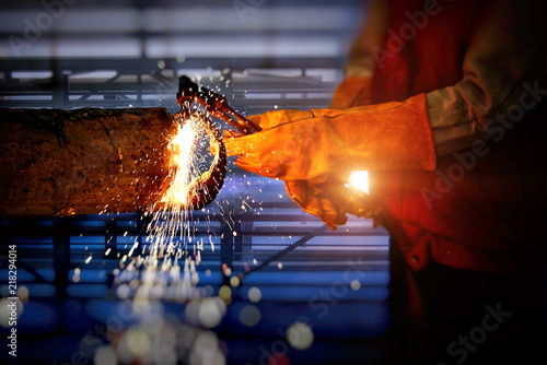 Close-up view of Industrial Worker at the factory welding .