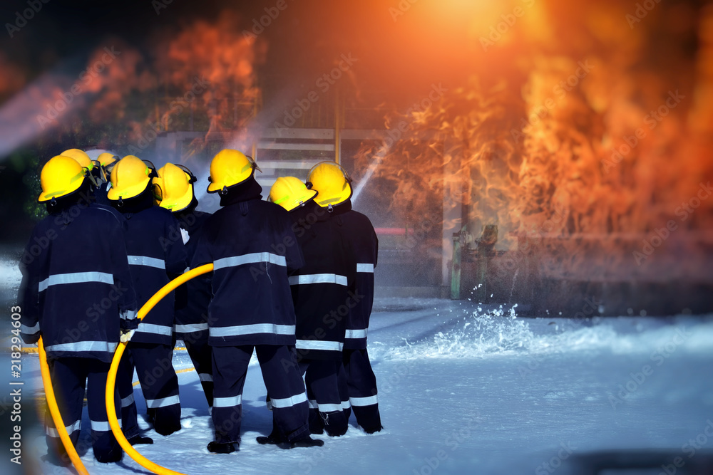 Fototapeta premium Fire in the Industrial Factory.A group of firefighters helped stop the fire.