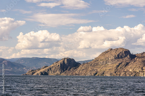 Okanagan lake at summer day with clouds on the sky.