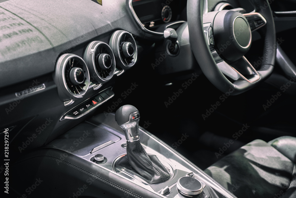 Luxury of car interior at transmission shift gear area. Modern car interior, gearstick radio and cup holder..