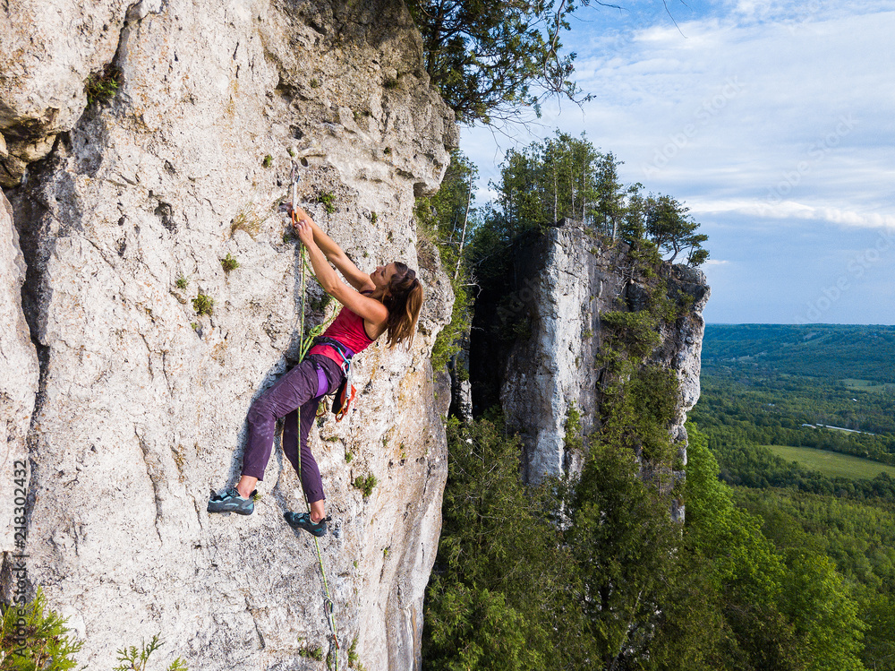 A beautiful woman rock climbing in Ontario, Canada.