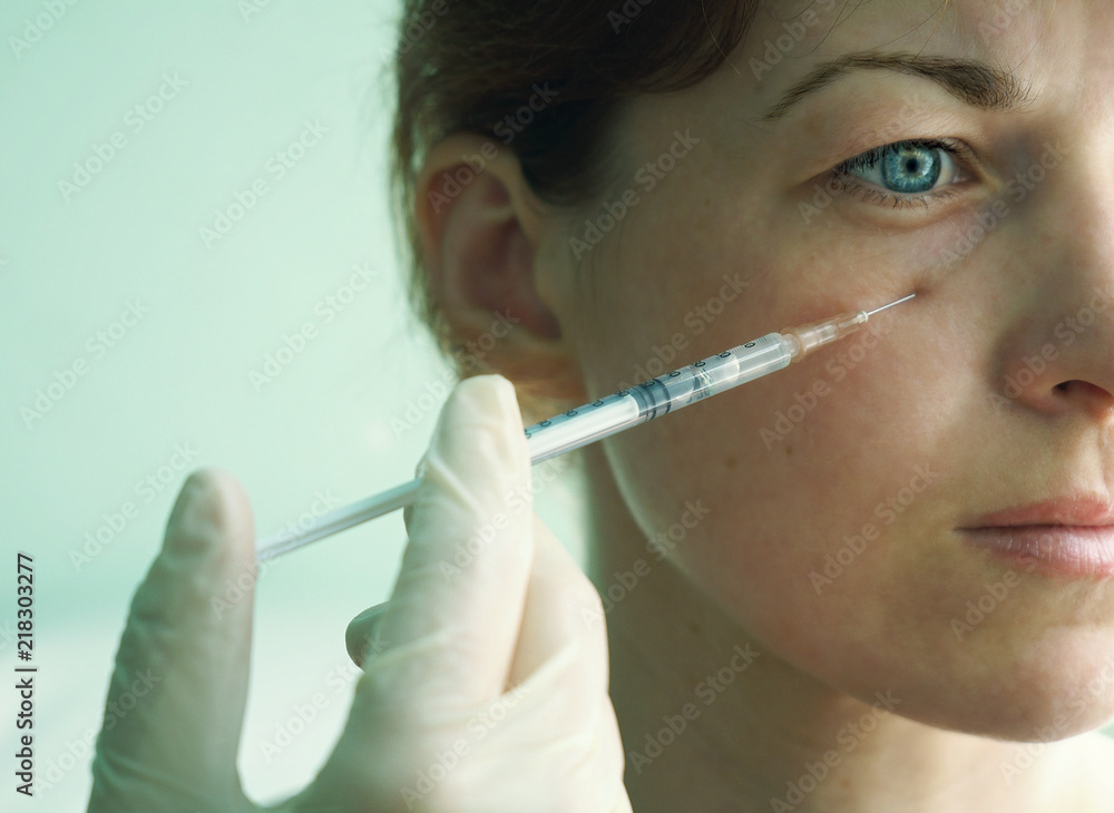 the girl with blue eyes doctor cosmetologist makes injections in the area under the eyes, relieving her from bags and bruises under the eyes, using injections of beauty the girl with blue eyes doctor cosmetologist makes injections in the area under the eyes, relieving her from bags and bruises under the eyes, using injections of beauty