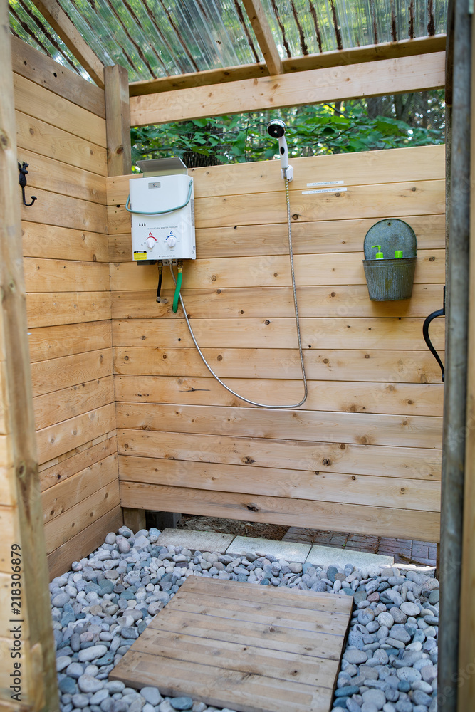 Outdoor shower stall at a glamping site