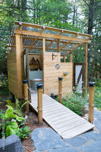 Obraz na płótnie Outdoor shower and composting toilet stall at a glamping site w salonie