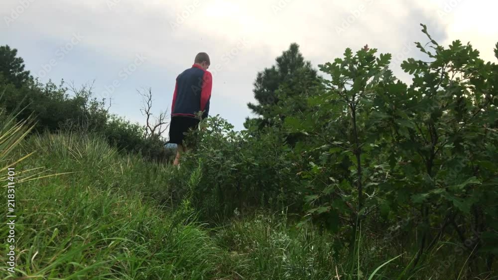 Me walking on a trail through some bushes away from the camera Me walking on a trail through some bushes away from the camera