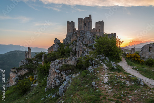 Rocca Calascio (Italy) - The ruins of an old medieval village with castle and church, over 1400 meters above sea level on the Apennine mountains in the heart of Abruzzo, at sunset.