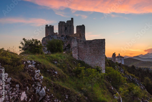 Rocca Calascio (Italy) - The ruins of an old medieval village with castle and church, over 1400 meters above sea level on the Apennine mountains in the heart of Abruzzo, at sunset.