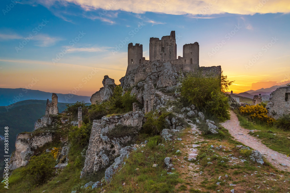 Rocca Calascio (Italy) - The ruins of an old medieval village with castle and church, over 1400 meters above sea level on the Apennine mountains in the heart of Abruzzo, at sunset.