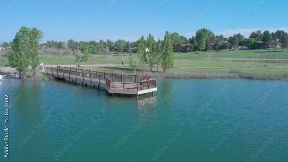 Drone shot of people relaxing near the water of a blue lake in Colorado Drone shot of people relaxing near the water of a blue lake in Colorado