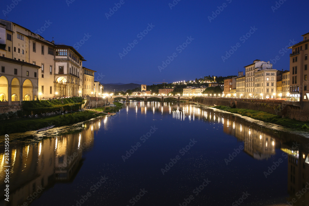 Florence, Italy, Arno river, view from Ponte Vecchio  at Ponte alle Grazie, dark blue sky, yelow lamps, Lungarno Acciaiuoli