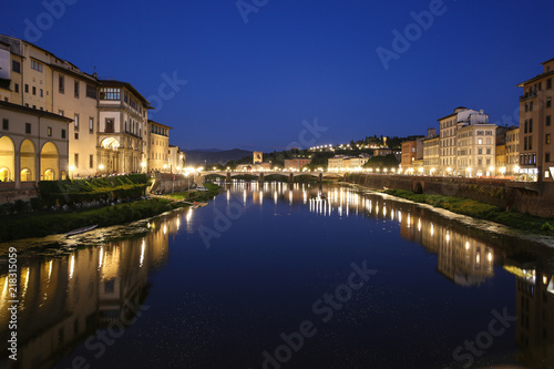 Florence, Italy, Arno river, view from Ponte Vecchio at Ponte alle Grazie, dark blue sky, yelow lamps, Lungarno Acciaiuoli