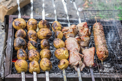Preparation of meat with crispy crust and potatoes on the grill