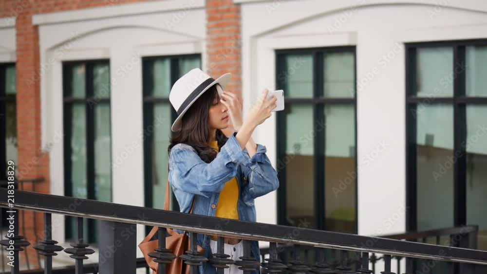 Young asian woman using smartphone take photo around community mall. Beautiful asian girl tourist travel to thailand. Young asian woman using smartphone take photo around community mall. Beautiful asian girl tourist travel to thailand.