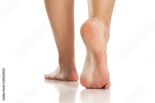 female bare feet on white background photo