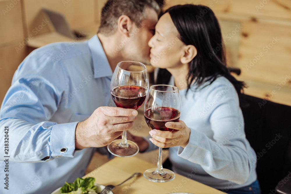 Great evening. High-spirited cheerful man and woman resting while drinking wine in a restaurant Great evening. High-spirited cheerful man and woman resting while drinking wine in a restaurant