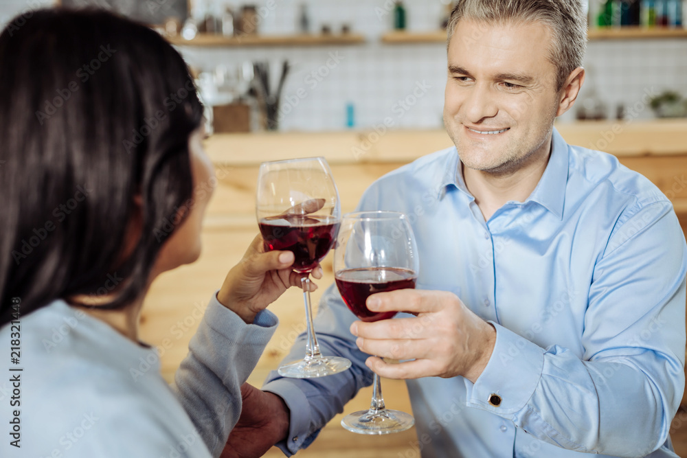 Happy time. Good-looking man having a date with a lady while drinking good wine Happy time. Good-looking man having a date with a lady while drinking good wine