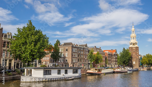 Historical tower Montelbaanstoren and houseboats in Amsterdam  Netherlands
