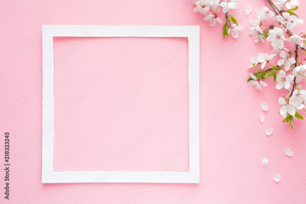 Fresh branches of cherry white blossoms with petals on pastel pink background. Soft light color. Mockup for positive ideas. Empty place for inspirational, emotional, sentimental text or quote.