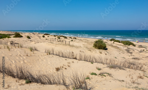 Long sandy beach called Playa El Moncayo. Blue sea and sky.