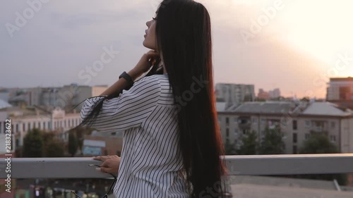 Pretty attractive young woman portrait on rooftop in sunset time