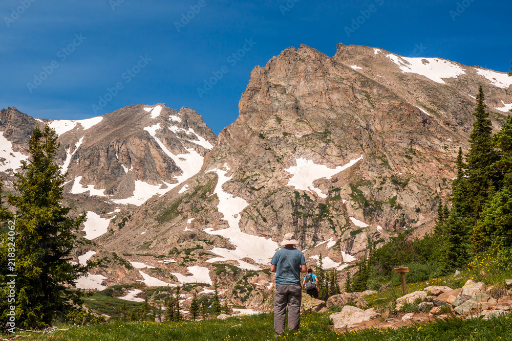 Man standing against a view of mountains Man standing against a view of mountains