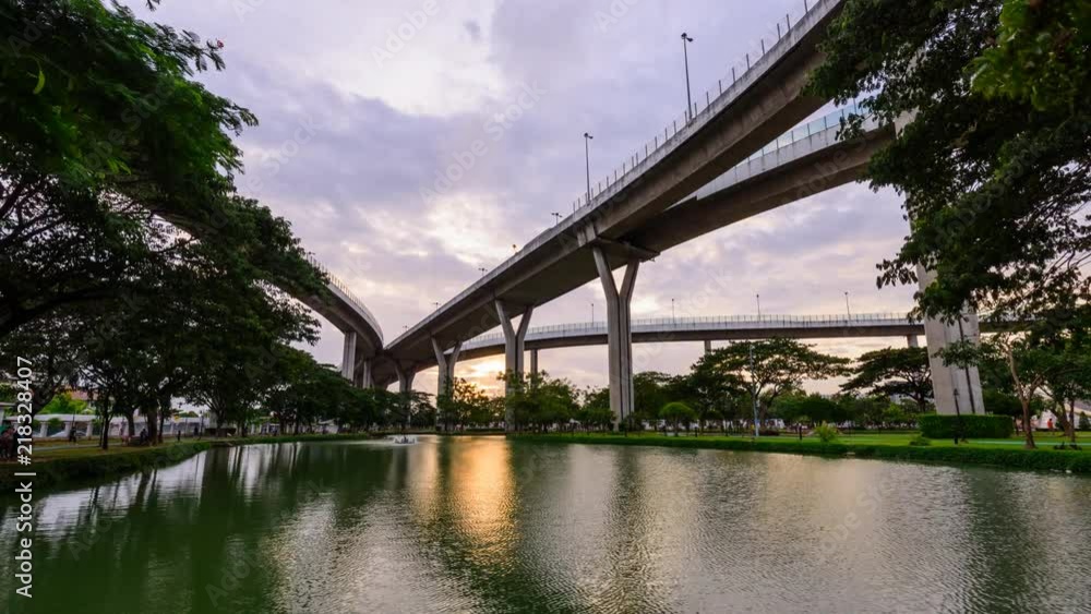 Time lapse uprisen angle view of expressway in sunset time with reflections on the water Time lapse uprisen angle view of expressway in sunset time with reflections on the water