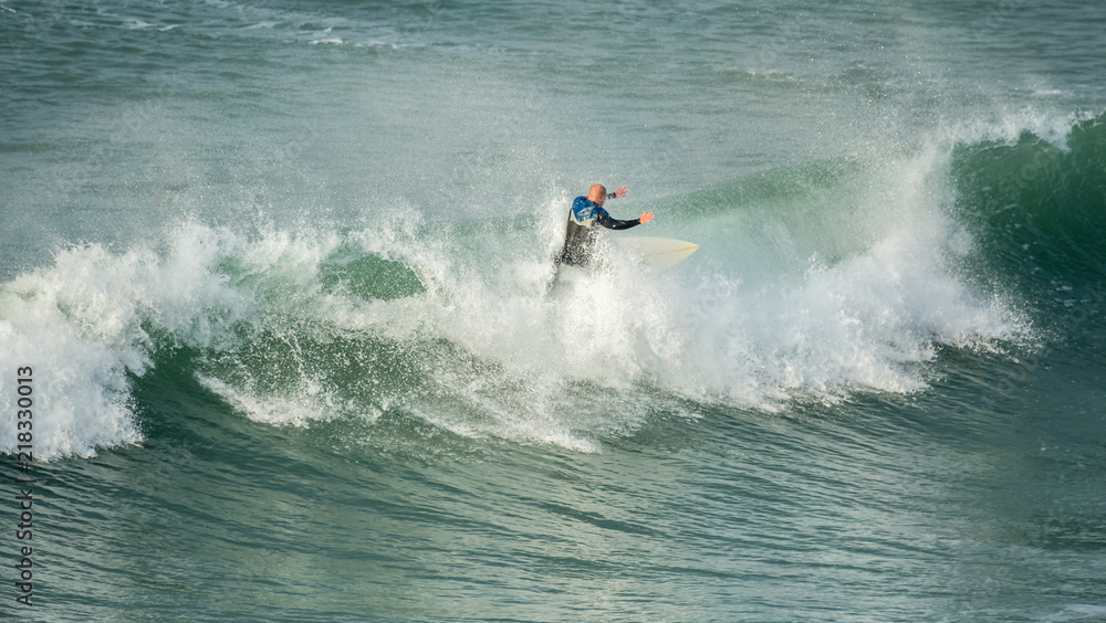 Surfer riding crest of wave, Fistral, Newquay, Cornwall Surfer riding crest of wave, Fistral, Newquay, Cornwall