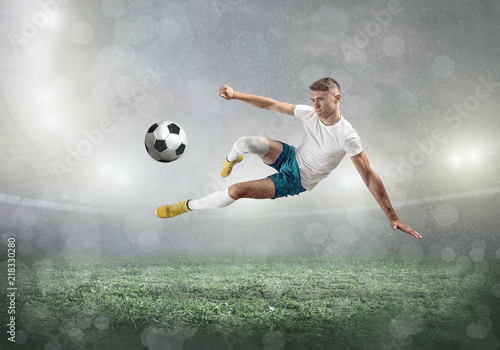 Soccer player on a football field in dynamic action at summer  © Andrii IURLOV