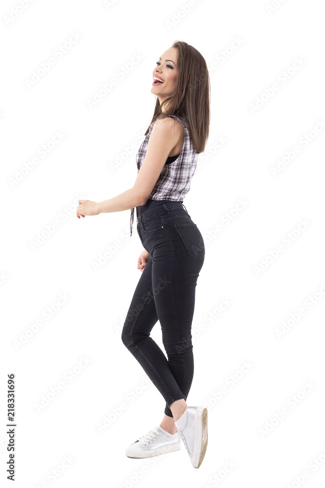 Side view of carefree relaxed young hipster girl laughing and looking up. Full body isolate on white background. Side view of carefree relaxed young hipster girl laughing and looking up. Full body isolate on white background.