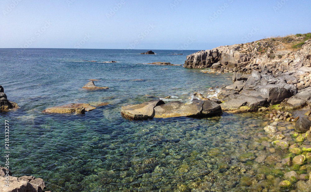 Fototapeta premium Cliff overlooking the Mediterranean sea in a bay at the island of Carloforte in Sardinia, Italy.