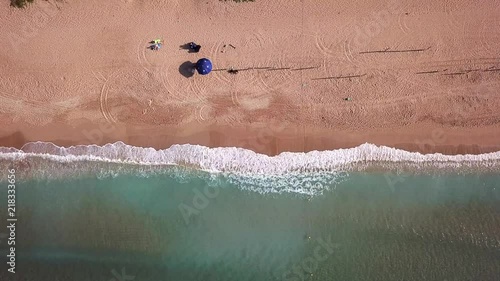 Aerial shot looking down on ocean waves against a sandy beach during a vacation in Kenting, Taiwan. photo