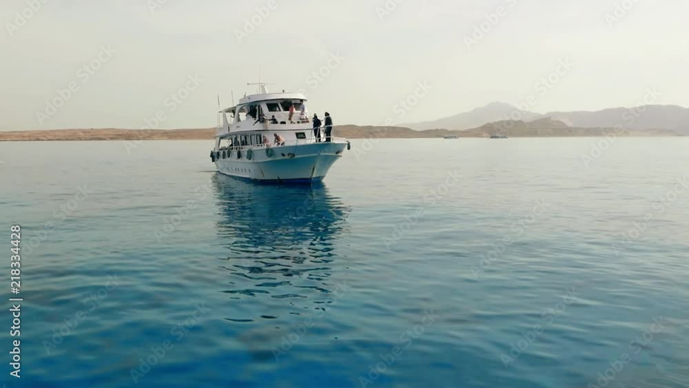 Tourism and travel. Tourist marine yacht, ship moored in the sea near island Tourism and travel. Tourist marine yacht, ship moored in the sea near island