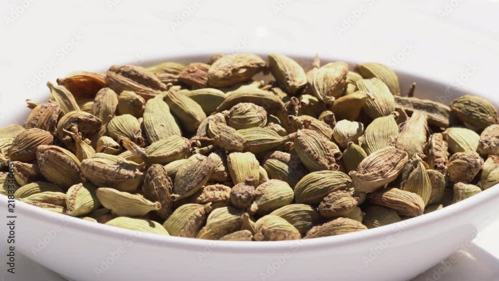 Dry spices cardamom on a rotary table. 4K. Macroshooting. Dry spices cardamom on a rotary table. 4K. Macroshooting.