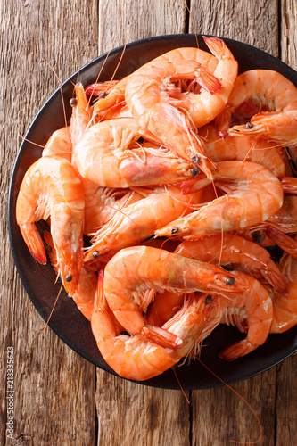 dish with boiled king prawns close-up on a plate. Food background. vertical top view