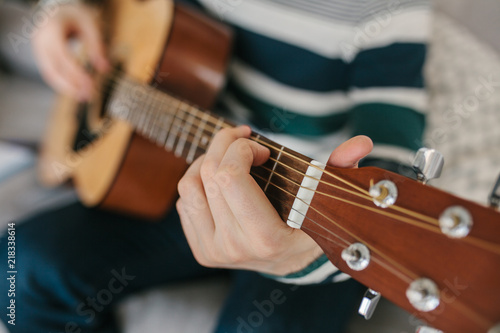 Learning to play the guitar. Music education and extracurricular lessons.