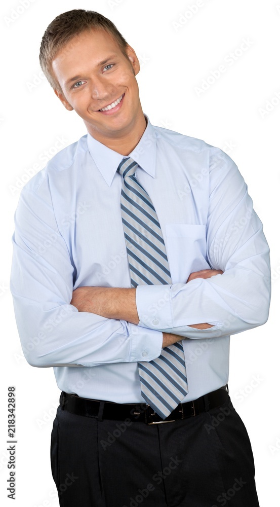 Professional looking man with his arms crossed wearing a button Professional looking man with his arms crossed wearing a button