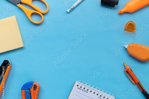 Flat lay picture of stationery and office supplies on blue color paper background. close up