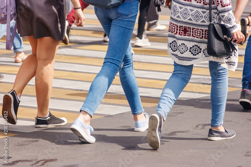 young woman feet, crossing an urban street