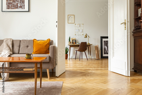 Tableau sur toile Real photo of a retro living room interior and view of a home office