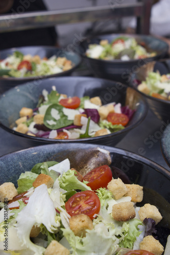 Greek salad served in black plates.