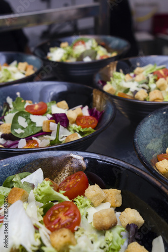 Greek salad served in black plates.
